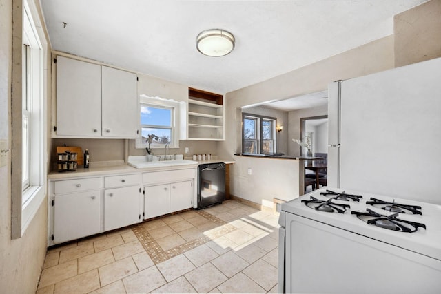 kitchen with white appliances, a sink, white cabinetry, light countertops, and open shelves