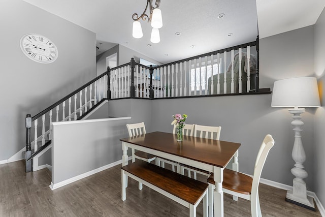 dining space with an inviting chandelier and dark hardwood / wood-style flooring