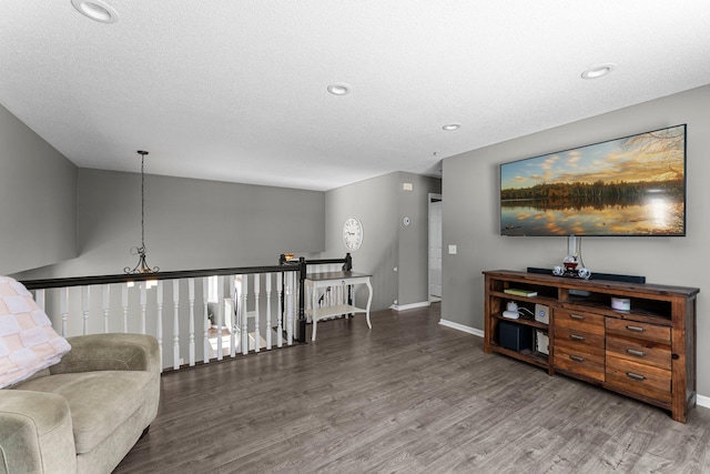 living area featuring hardwood / wood-style flooring and a textured ceiling