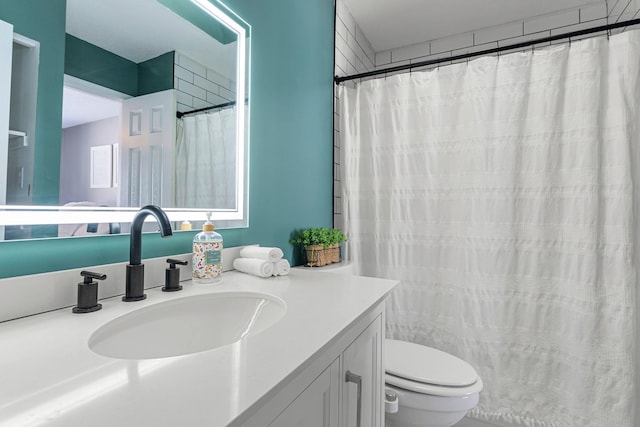 bathroom featuring vanity, a shower with shower curtain, and toilet