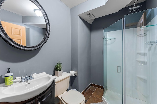 bathroom featuring vanity, toilet, an enclosed shower, and tile patterned flooring