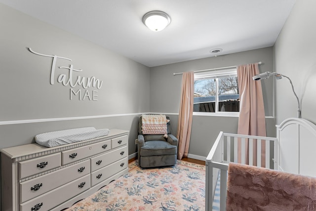 bedroom featuring a nursery area