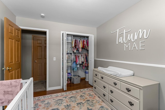 bedroom with light hardwood / wood-style floors and a closet