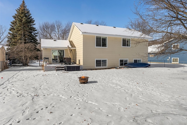 snow covered house with a fire pit