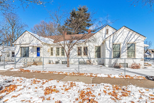 view of front of house featuring a fenced front yard, driveway, and stucco siding