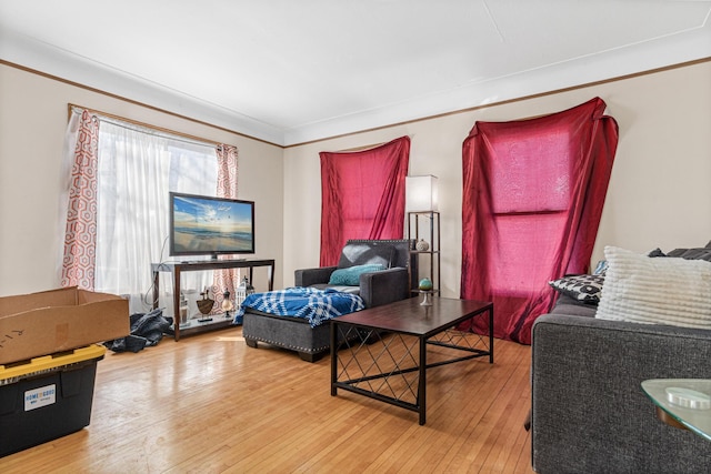 living room featuring hardwood / wood-style flooring and ornamental molding