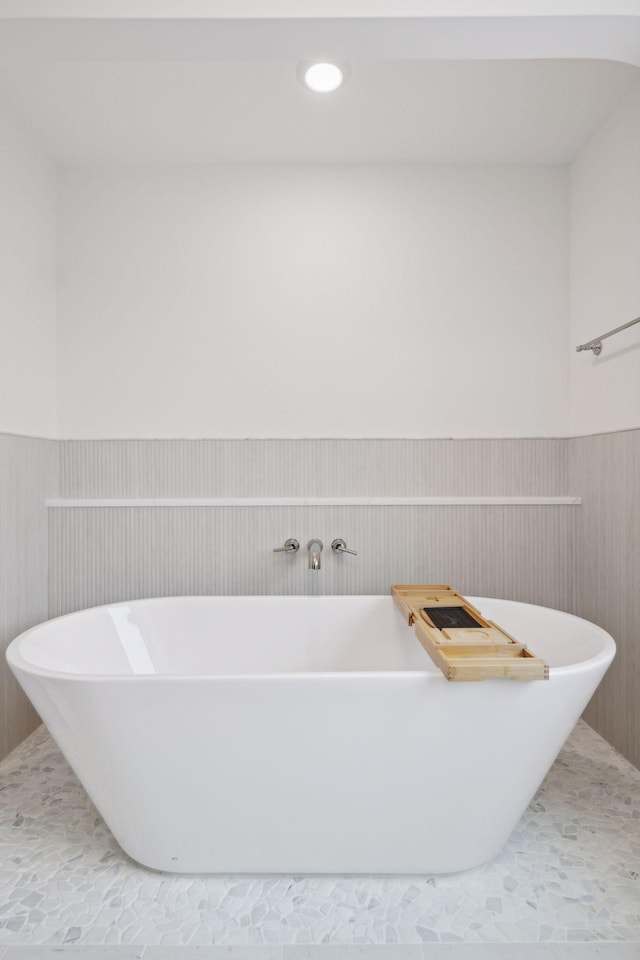 bathroom with tile patterned flooring and a bathtub