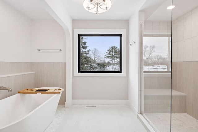 bathroom with separate shower and tub