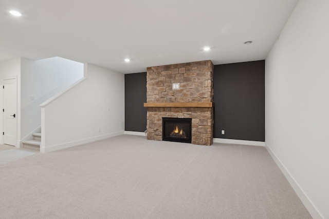 unfurnished living room featuring a fireplace and light colored carpet