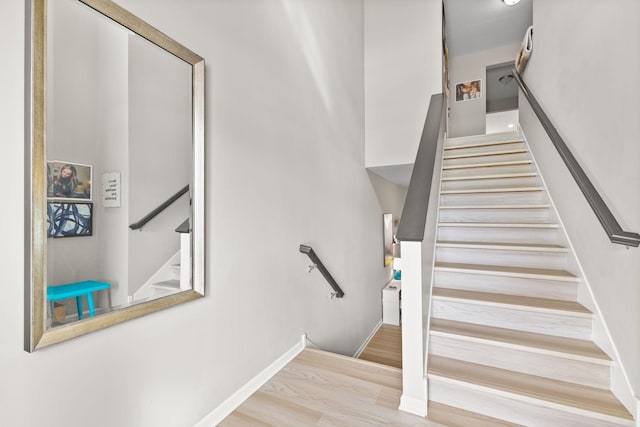 stairway with hardwood / wood-style flooring