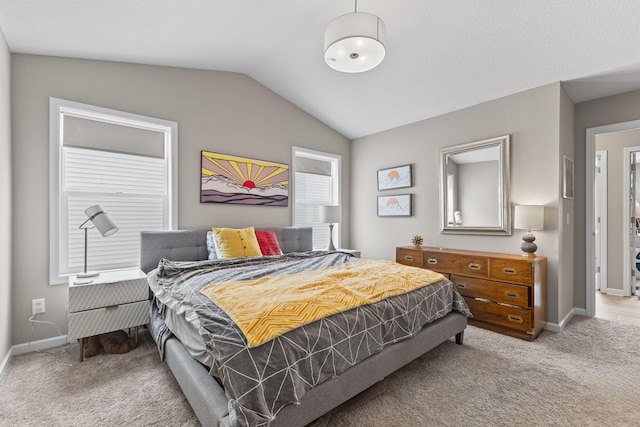 bedroom featuring light carpet and vaulted ceiling