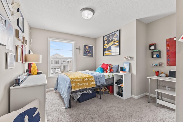 bedroom featuring light colored carpet and a textured ceiling