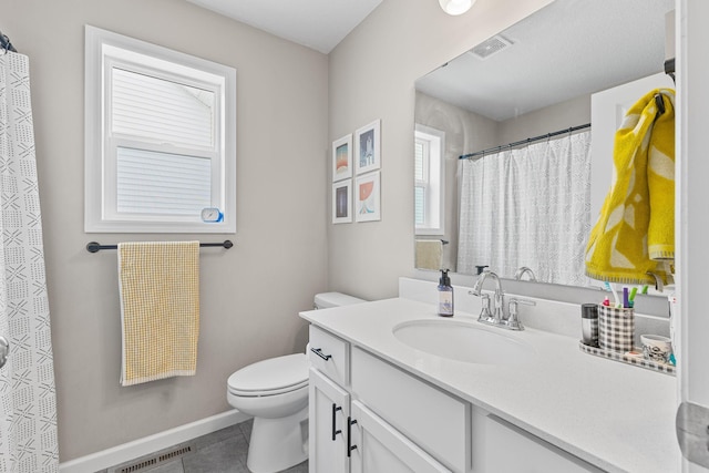 bathroom featuring vanity, tile patterned flooring, and toilet