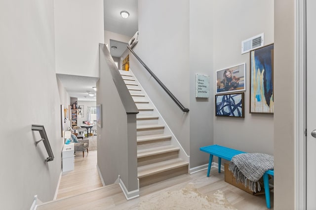 stairs with hardwood / wood-style floors