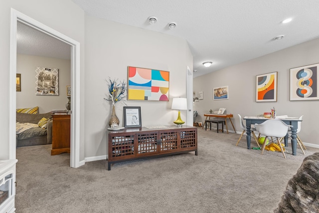 playroom with light carpet and a textured ceiling