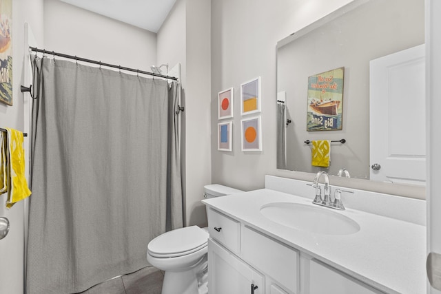 bathroom featuring tile patterned flooring, vanity, and toilet