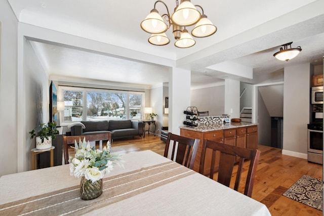 dining room with a chandelier and light hardwood / wood-style floors