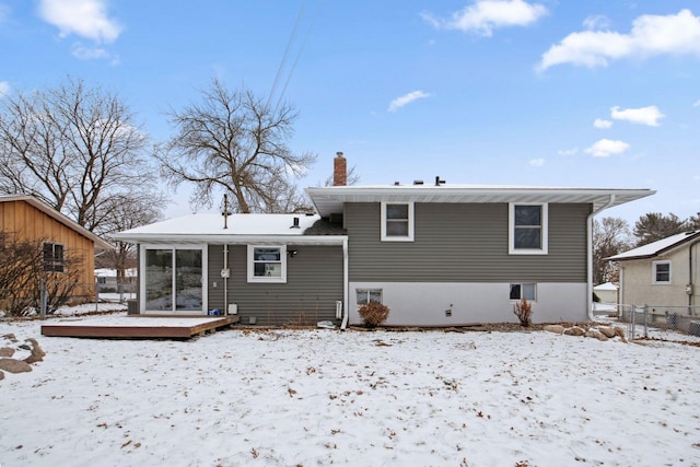 view of snow covered back of property