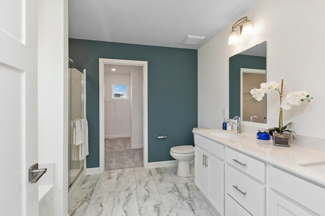 bathroom featuring vanity, toilet, and a shower with shower door