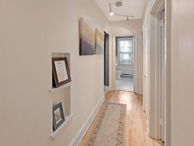 corridor with light hardwood / wood-style flooring