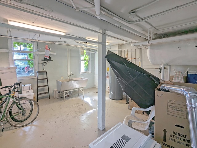 basement featuring electric water heater and sink