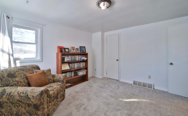 sitting room featuring visible vents and carpet flooring