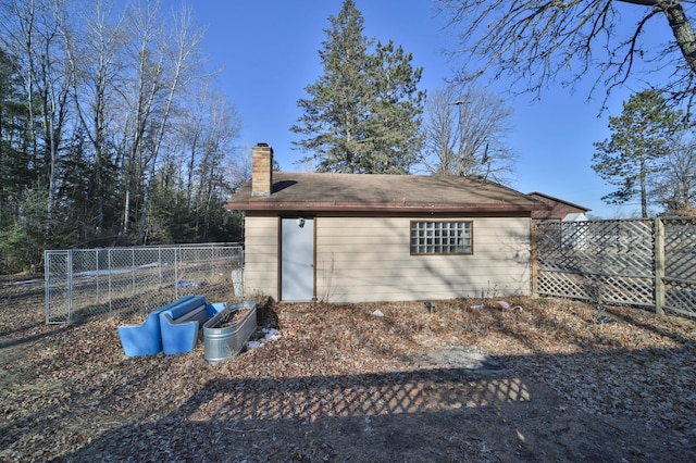 view of outbuilding featuring fence