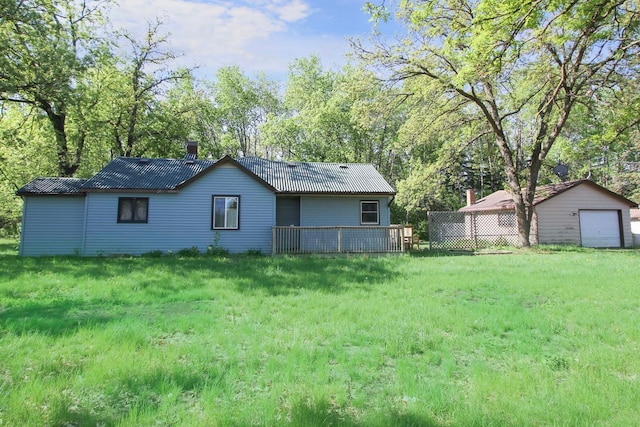 34007 Sunset Loop, Motley, MN 56466 - back of house featuring a garage, metal roof, a lawn, and view of wooded area