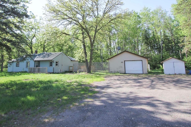 34007 Sunset Loop, Motley, MN 56466 - detached garage featuring asphalt driveway and a storage unit