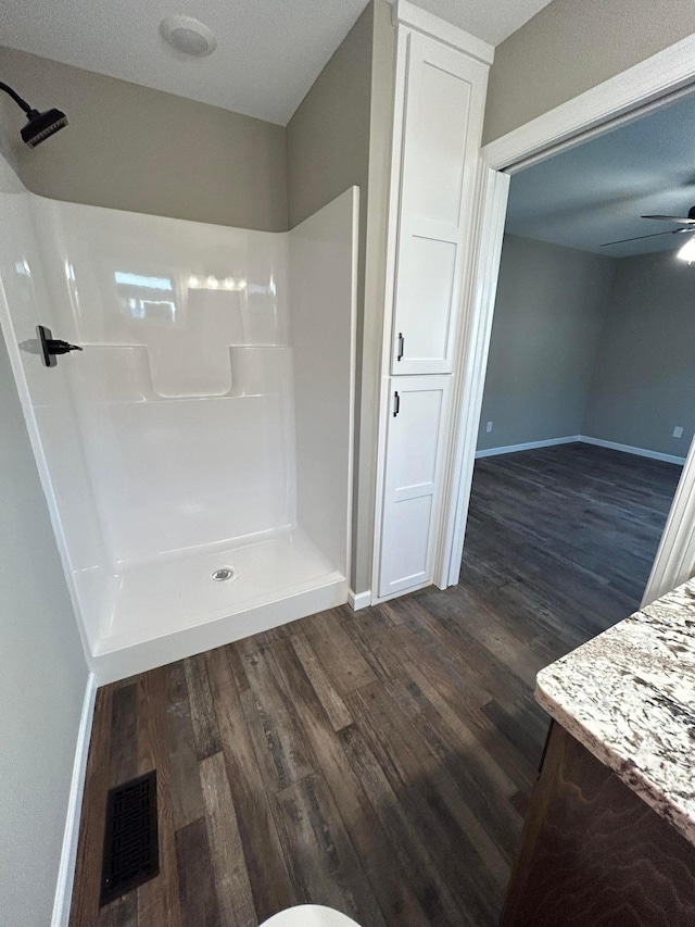 11252 Prairie Village Ln, Becker, MN 55308 - bathroom with hardwood / wood-style floors, a shower, and ceiling fan