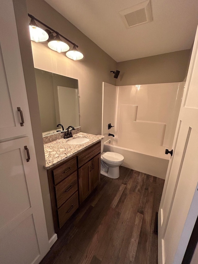 11252 Prairie Village Ln, Becker, MN 55308 - full bathroom featuring wood-type flooring, bathtub / shower combination, vanity, and toilet