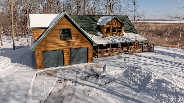 cabin with a garage and covered porch