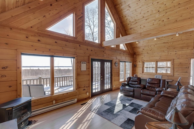 living room featuring high vaulted ceiling, wooden walls, a baseboard radiator, wooden ceiling, and french doors