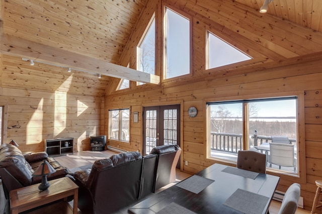 living room with wood ceiling, french doors, and wood walls