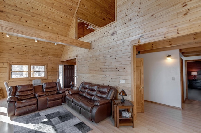 living room with wooden ceiling, light hardwood / wood-style floors, high vaulted ceiling, and wood walls