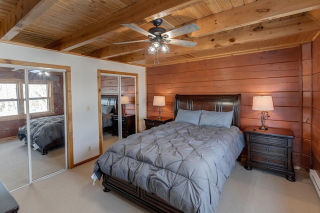 bedroom featuring wooden walls, beamed ceiling, light colored carpet, baseboard heating, and wooden ceiling