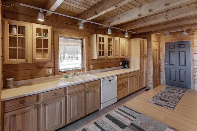 kitchen featuring sink, white dishwasher, light hardwood / wood-style floors, wooden ceiling, and wood walls