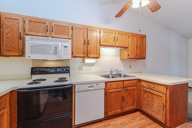 kitchen featuring sink, vaulted ceiling, ceiling fan, kitchen peninsula, and white appliances