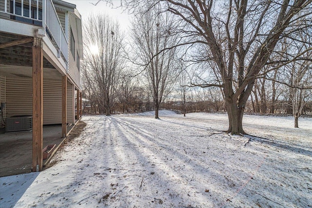 yard layered in snow with central air condition unit