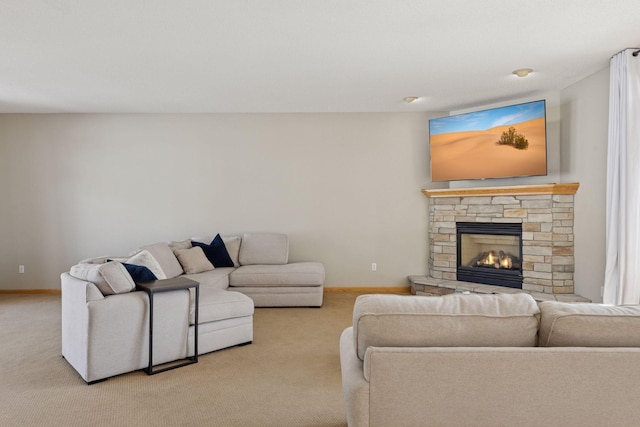 living room featuring a fireplace, baseboards, and carpet floors