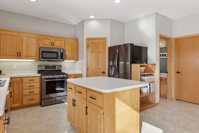 kitchen with recessed lighting, appliances with stainless steel finishes, a center island, and light countertops