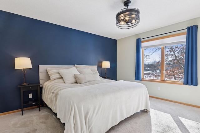 carpeted bedroom featuring baseboards