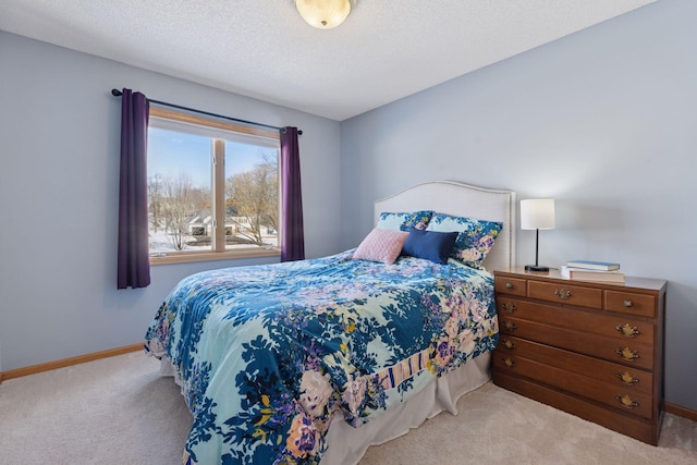 carpeted bedroom with baseboards and a textured ceiling