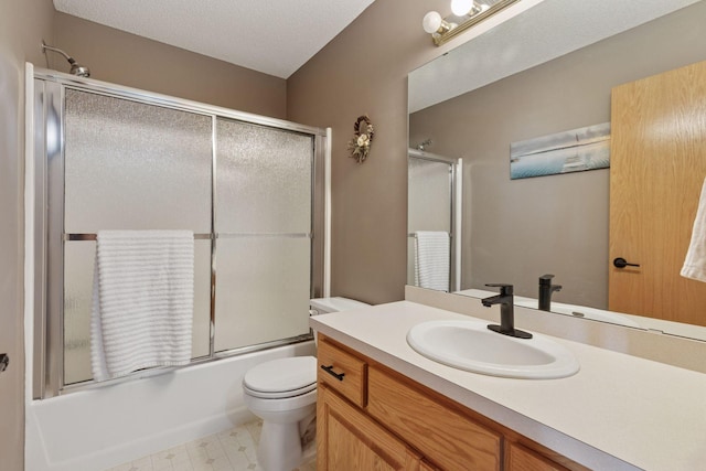 full bath with tile patterned floors, toilet, enclosed tub / shower combo, a textured ceiling, and vanity