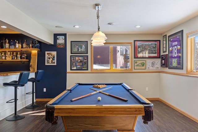 recreation room with pool table, a bar, baseboards, and wood finished floors