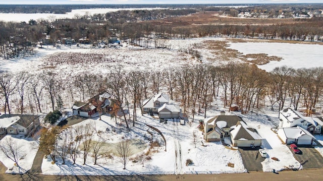 snowy aerial view with a residential view