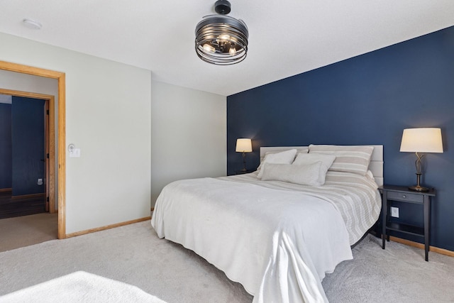 bedroom featuring baseboards and carpet floors