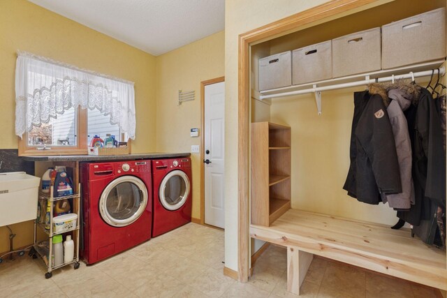 laundry room with light floors, laundry area, and washing machine and clothes dryer