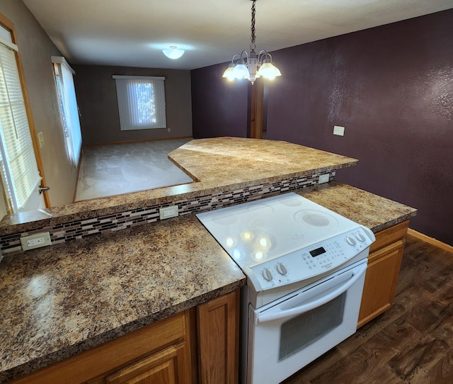 kitchen featuring dark wood-type flooring, hanging light fixtures, brown cabinets, white electric range oven, and an inviting chandelier