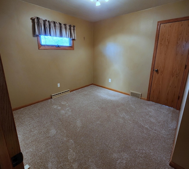 carpeted spare room featuring baseboards and visible vents